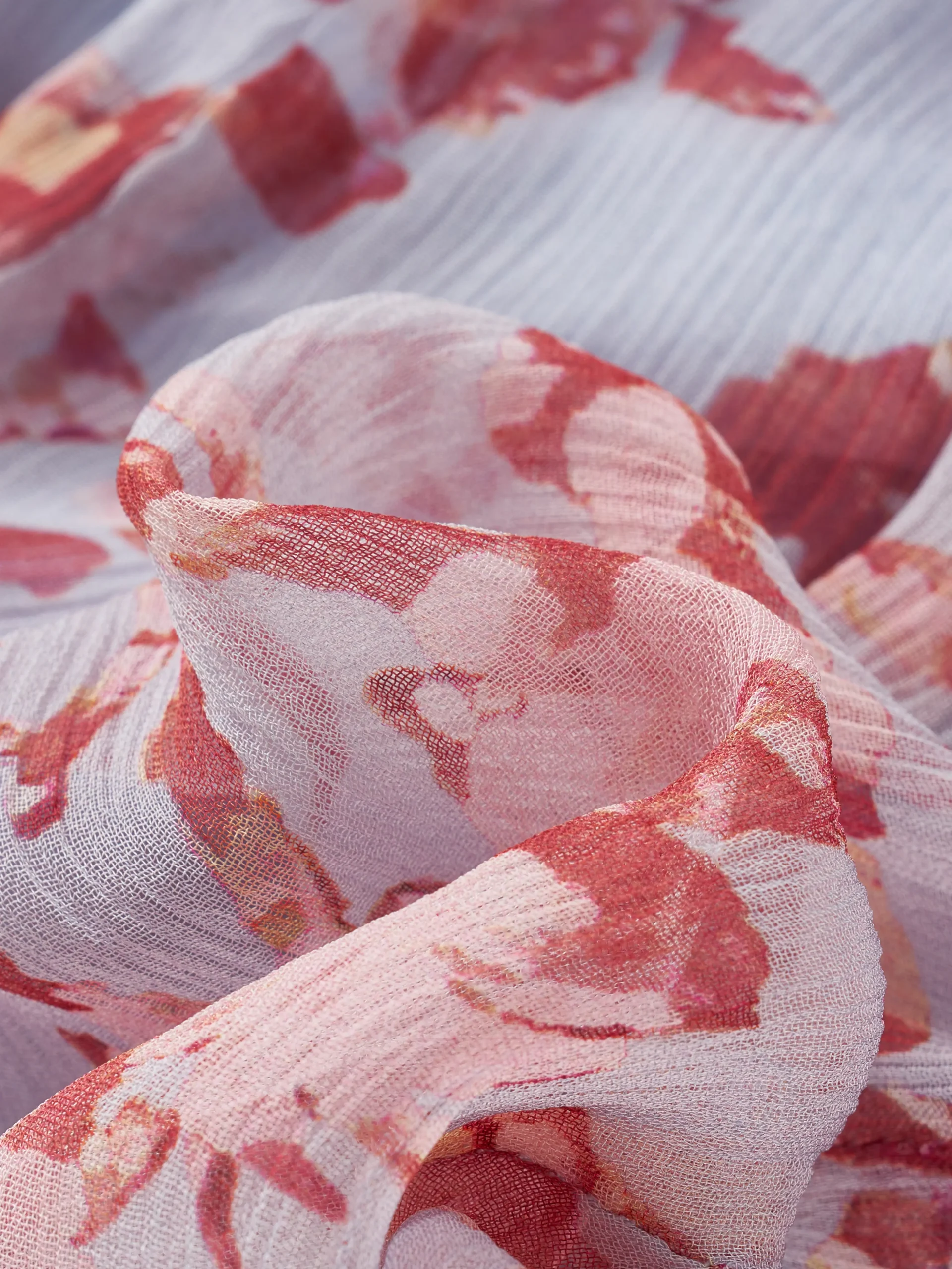 A lightweight floral mini dress featuring a feminine tie neckline, flutter sleeves, and a softly gathered waist. Its airy silhouette makes it ideal for summer collections, resort wear, and effortless everyday styling.