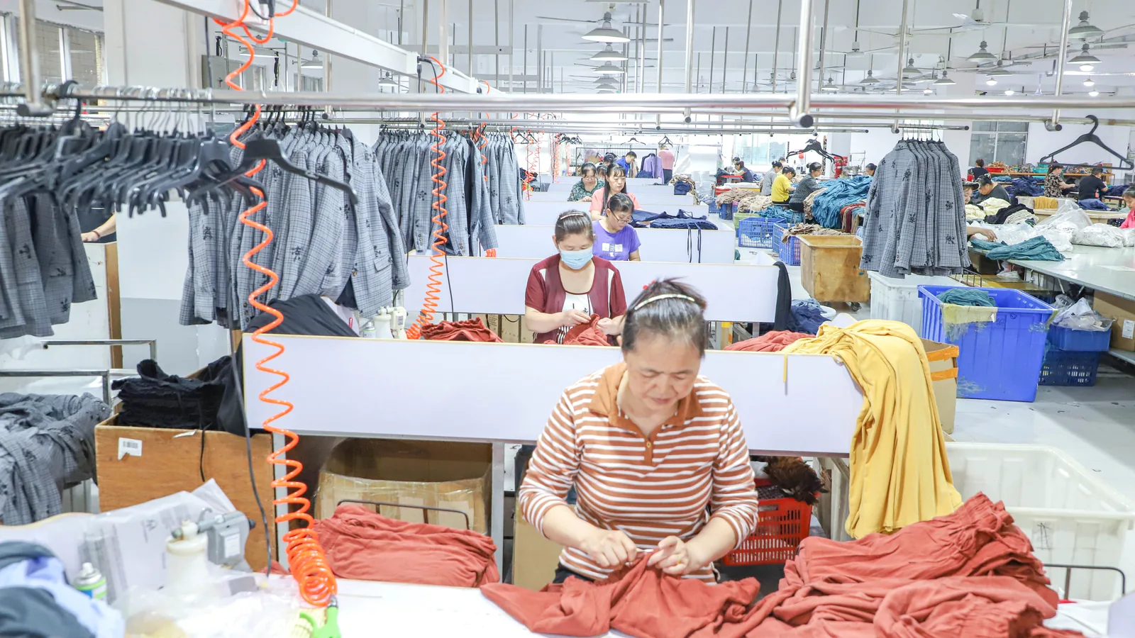Garment quality inspection and finishing at Shengfu clothing factory