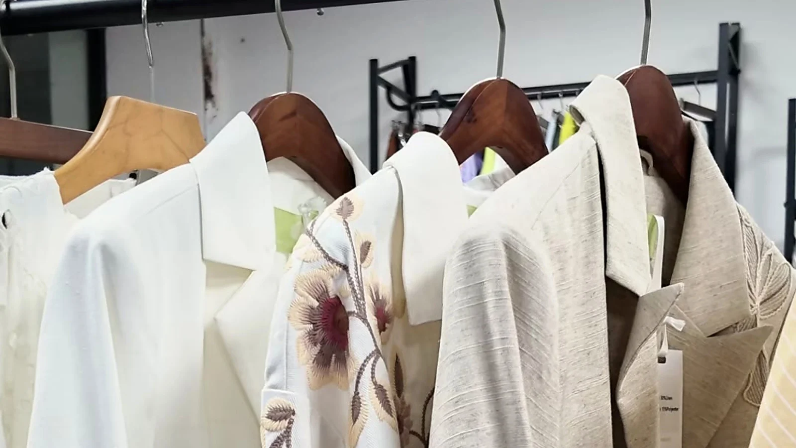 Rack of embroidered womenswear samples at Shengfu garment factory