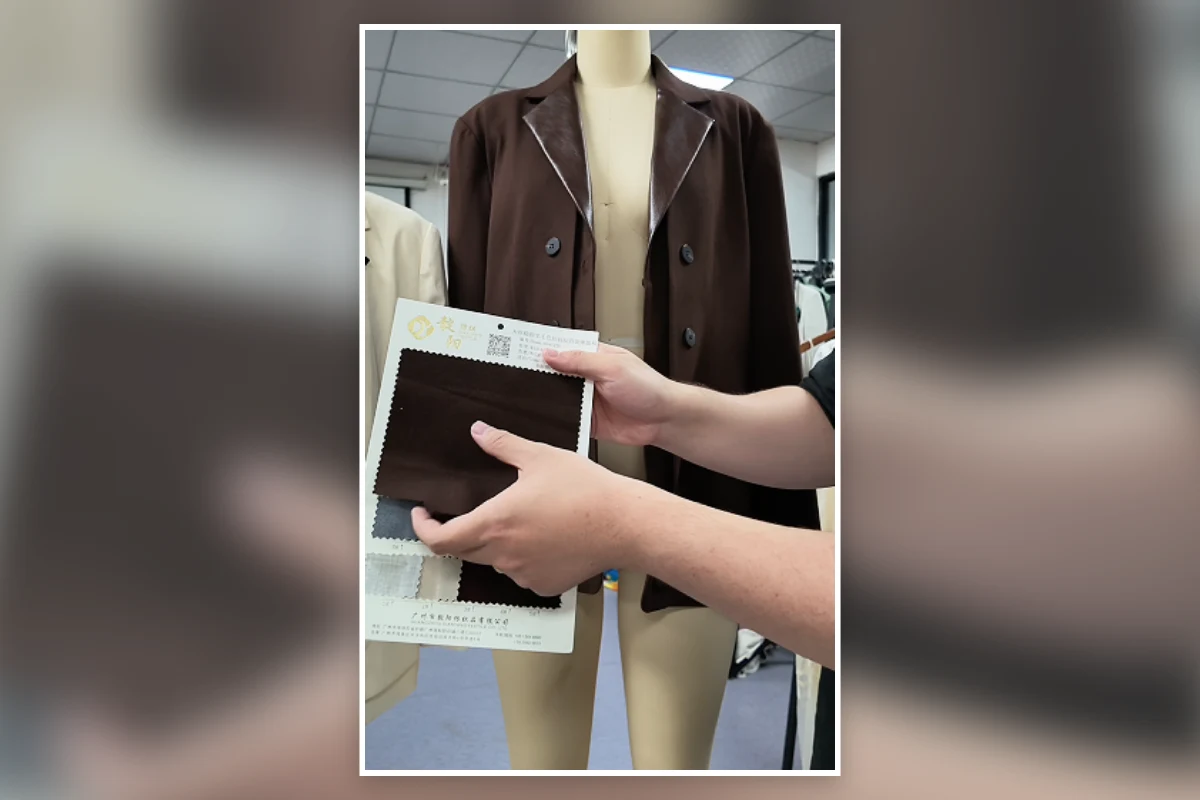 Shengfu reviewing fabric swatches before a bulk production payment stage