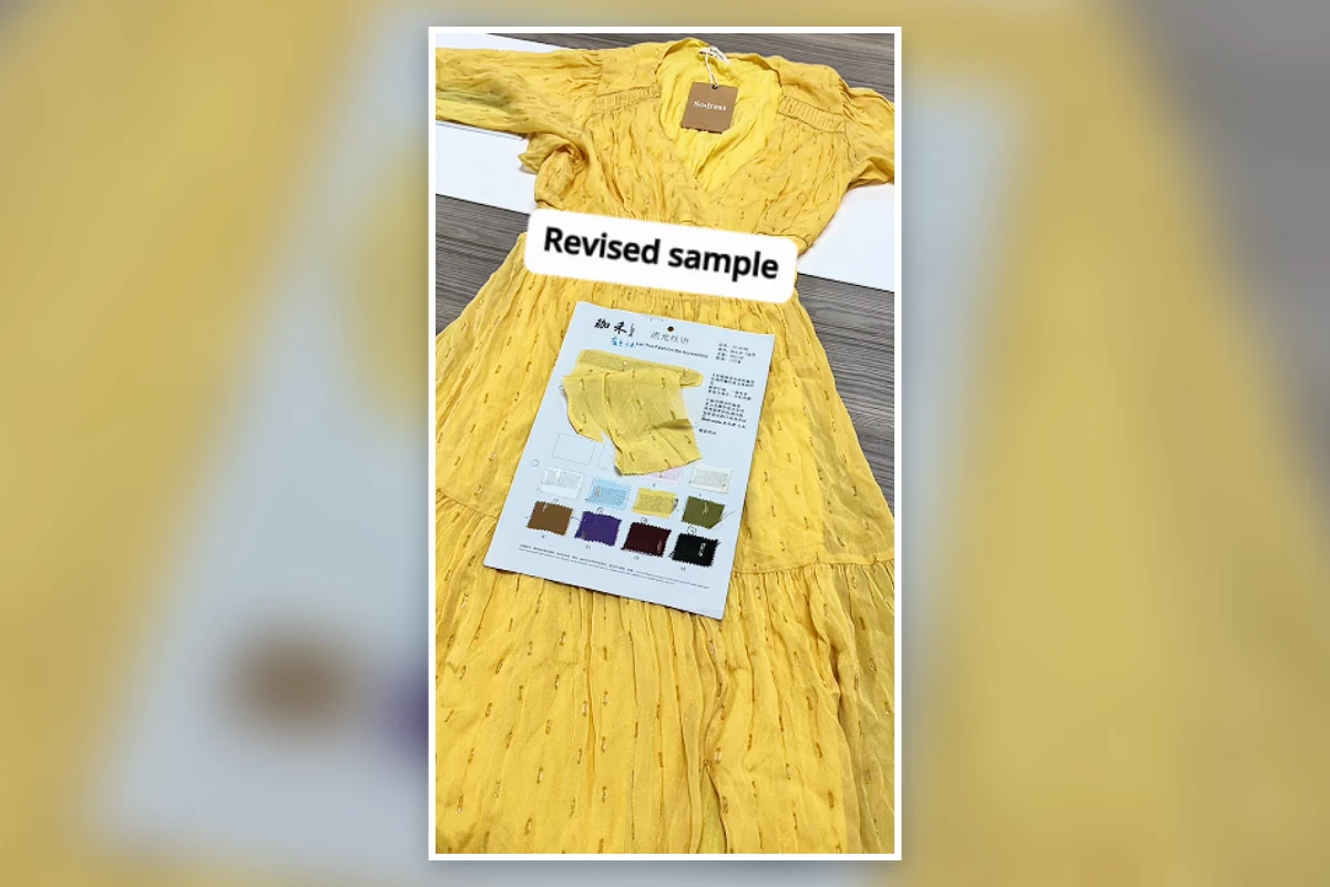 Revised yellow dress sample displayed with its approved fabric colour card