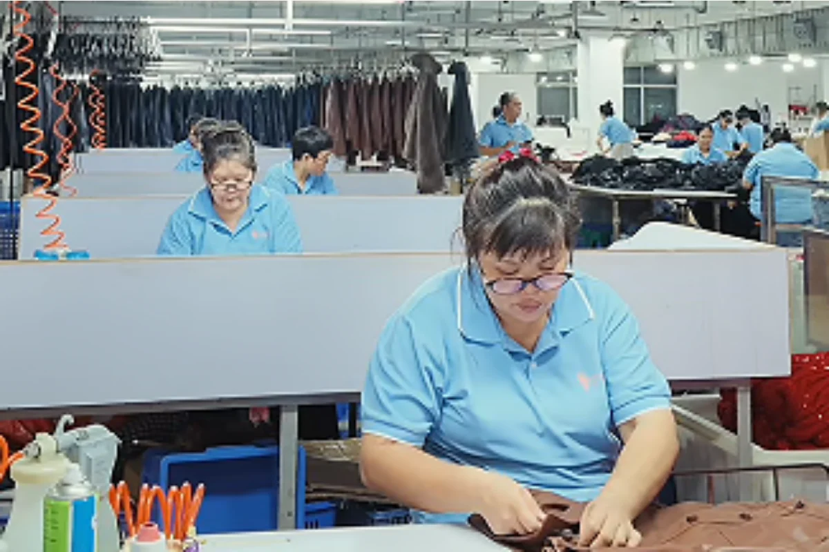Shengfu operator completing detailed custom dress workmanship in the factory
