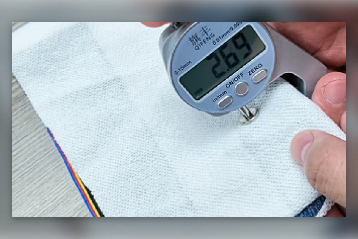 Shengfu technician measuring fabric GSM before confirming production cost