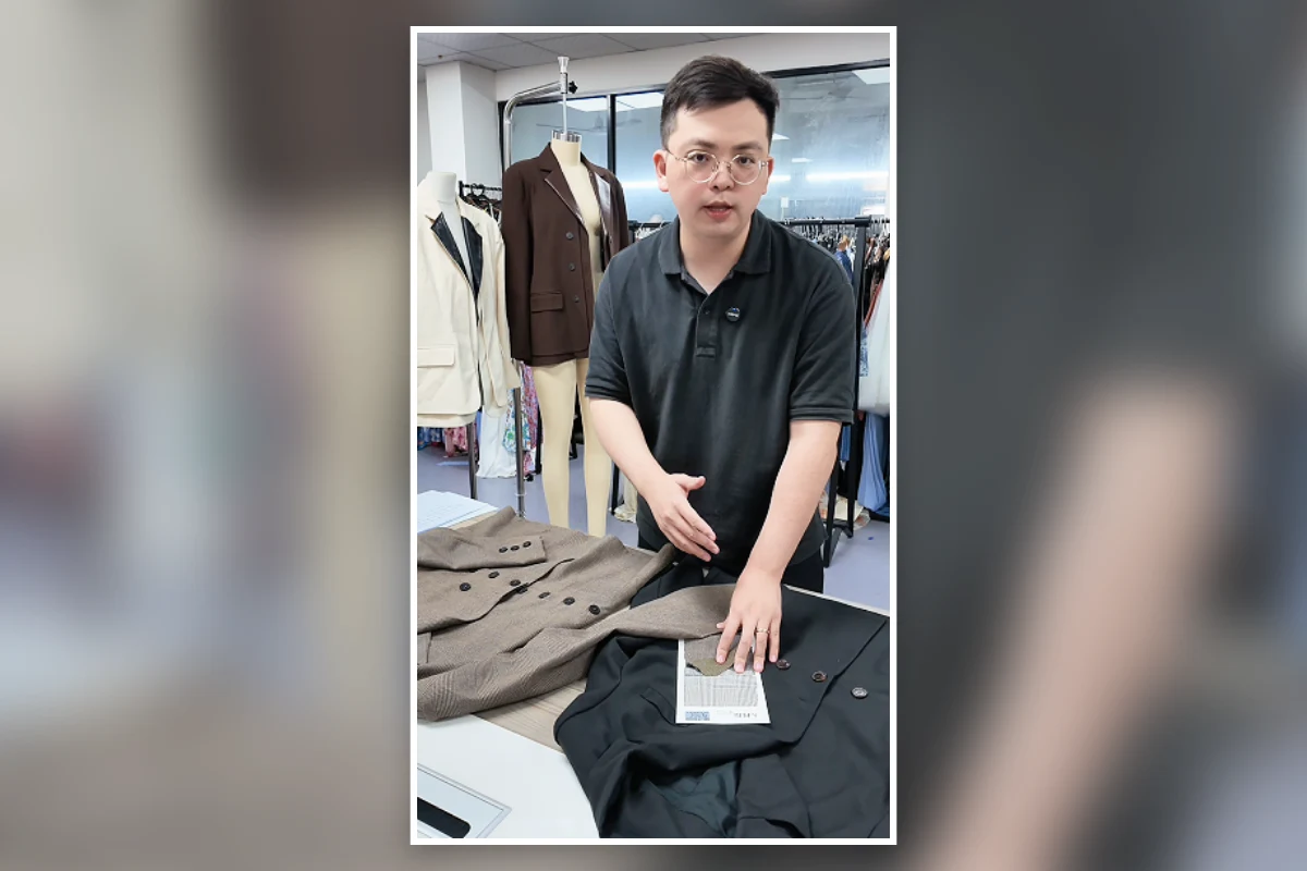 Shengfu garment developer reviewing womenswear samples and fabric swatches