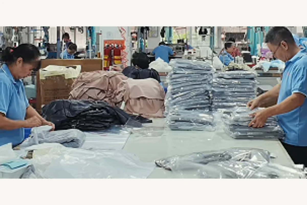 Garment finishing and packing team preparing completed clothing factory orders