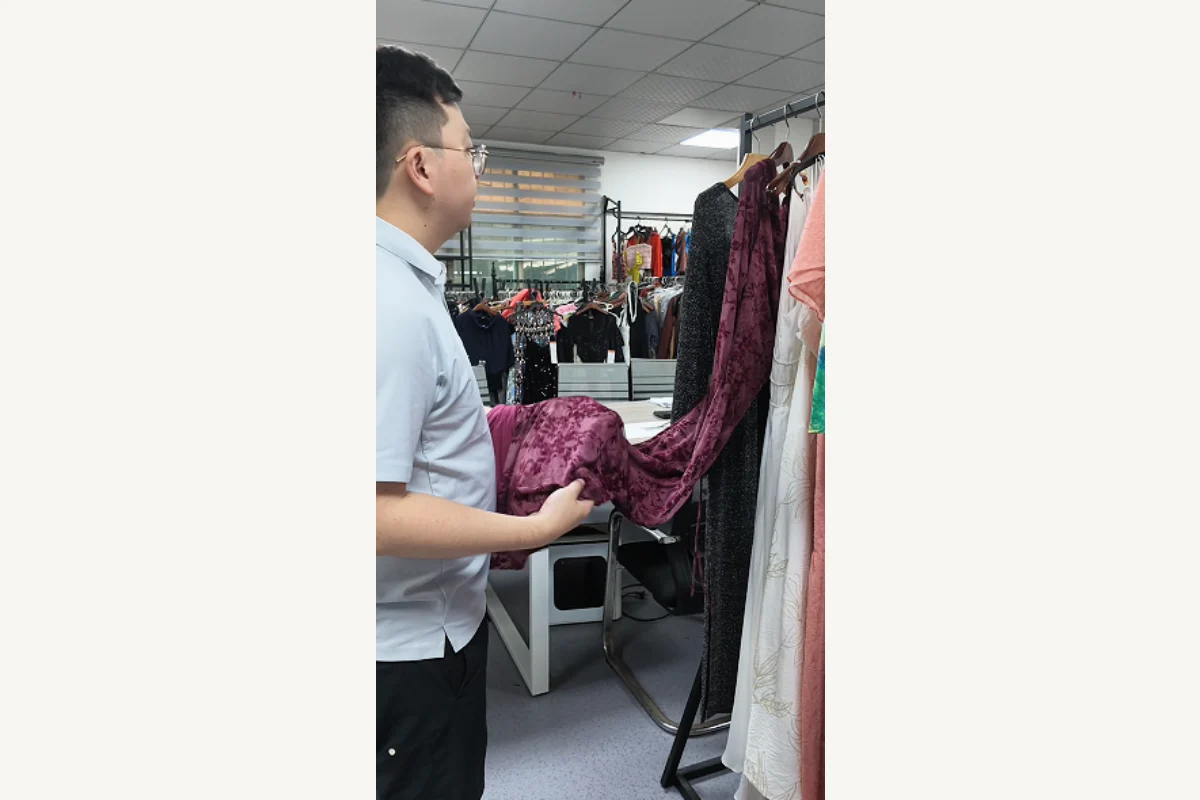 Shengfu womenswear team reviewing a dress sample in the factory