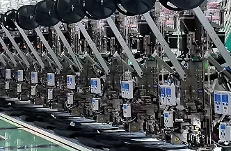 Row of multi-head embroidery machines