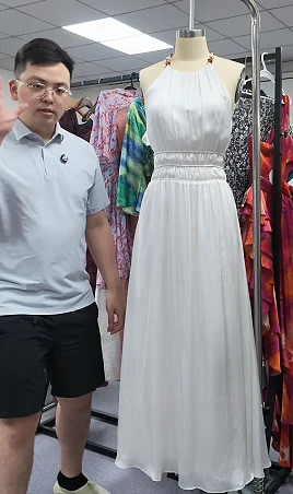 White dress on a form during a garment review