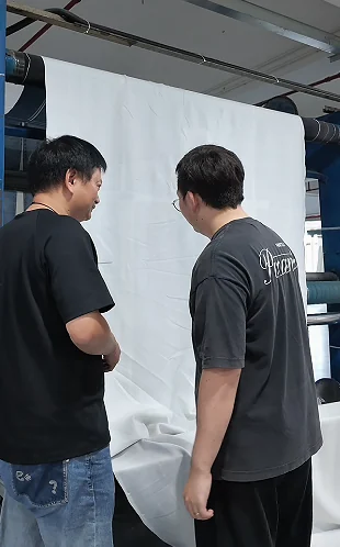 Two team members discussing material at a worktable