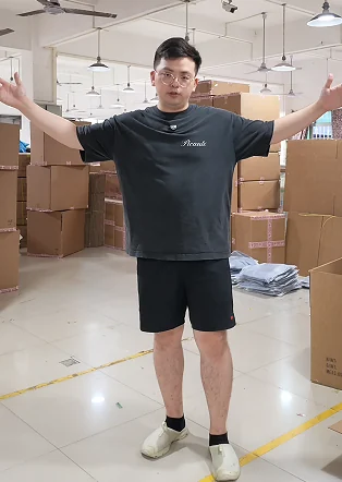 Team member standing beside packed cartons