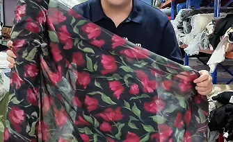 Printed floral fabric held open for discussion