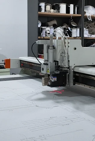 Cutting machine positioned over paper patterns