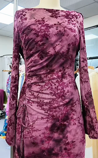 Long-sleeved pink patterned dress on a form
