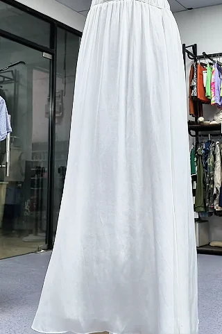 Long white skirt displayed on a dress form