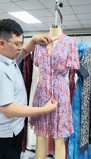 Reviewing a floral dress on a form