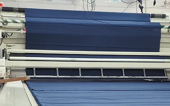 Roll-fed fabric at a production machine