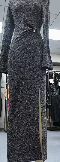 Dark long-sleeved dress displayed on a form