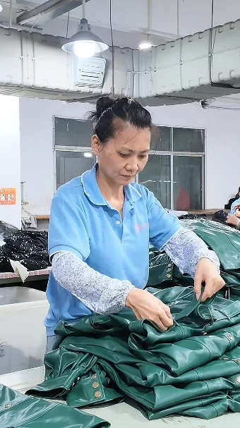 Worker finishing a green garment