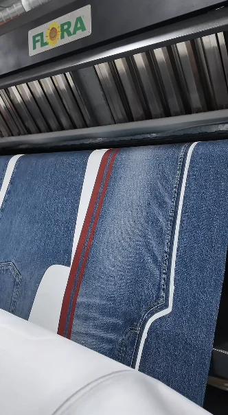 Printed garment panels emerging from a large-format machine