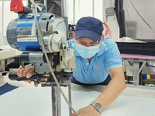 Worker operating a sewing machine