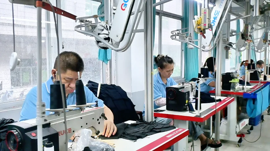 Worker sewing a light-coloured garment