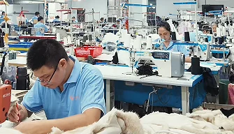 Worker sewing at a production workstation