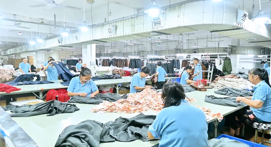 Wide view of workers and garments across production tables