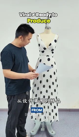 Man reviewing a light dress displayed on a dress form