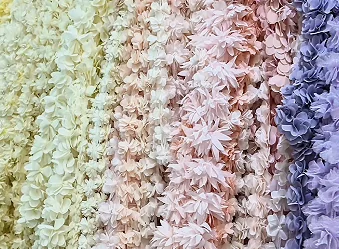 Textured fabrics displayed in several pale colours