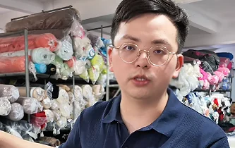 Fabric-sourcing discussion in front of textile rolls