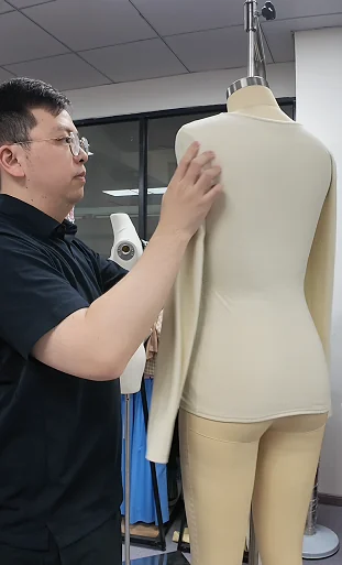 Dress form being reviewed with a measuring tape