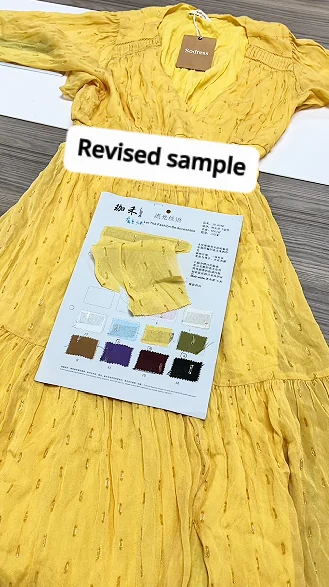 Yellow revised garment sample beside its specification sheet