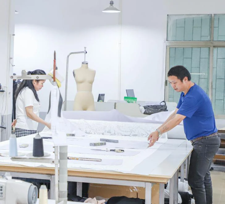 Shengfu sample room team preparing fabric and garment patterns at the cutting table