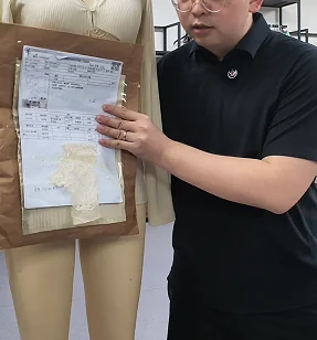 Specification sheet and fabric references beside a dress form